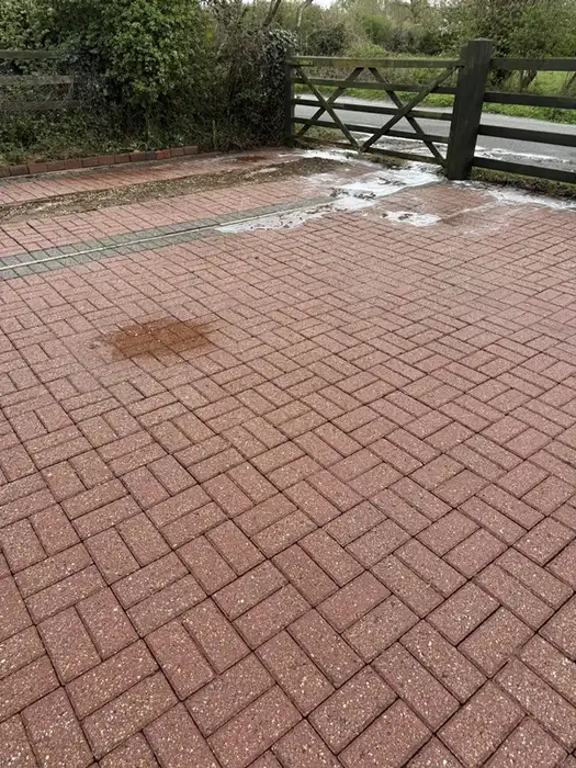 The same block paved driveway cleaned back to its original red brick colour
